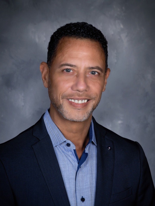 Photo of a man in dark blazer