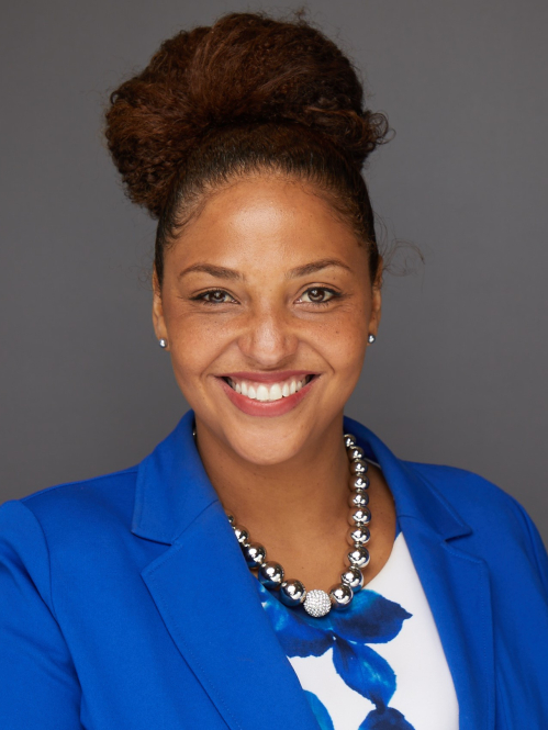 Head-and-shoulders portrait of woman in a blue suit and white blouse with blue pattern