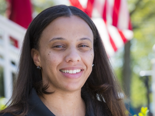 Woman in a Rutgers Veteran shirt smiling at the camera