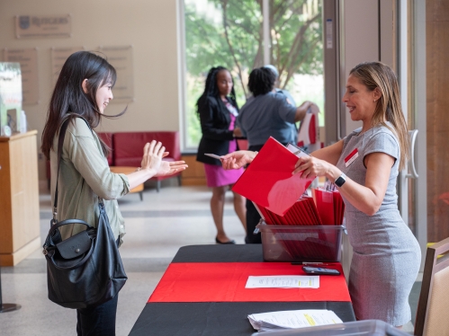 Student receiving red law school packet.