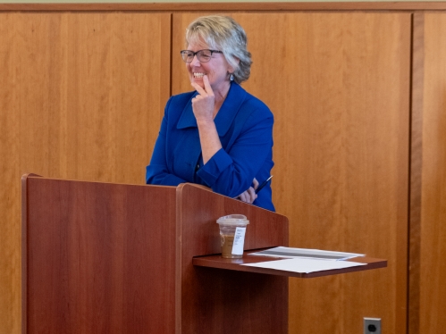 Teacher smiling at lectern