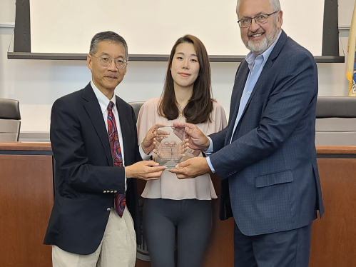 Intellectual Property Clinic instructors present an award to a student participant.