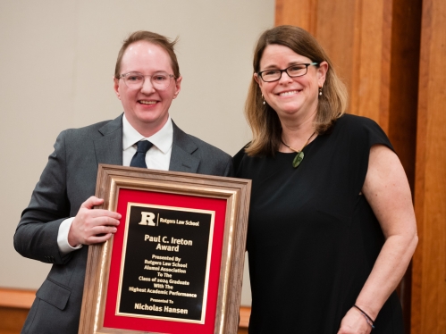 woman and man holding plaque