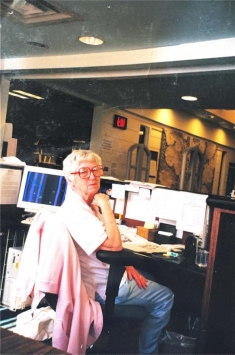 woman sitting in a library and posing for a photograph