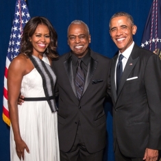 three people standing next to each other and posing for a photograph