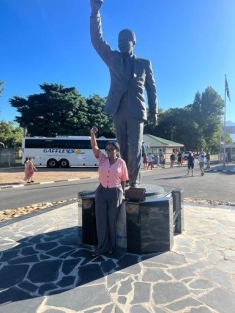 woman posing for a photograph in front of a statue