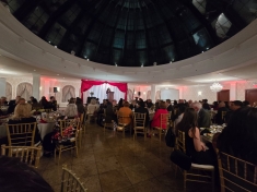 large ballroom with people seated at circular tables